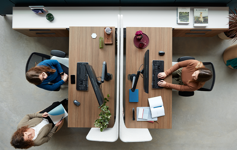 Bird's eye view of colleagues working from desks in office