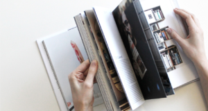 Image of hands flipping through pages of a magazine
