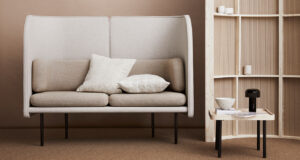 Neutral coloured seating area with high-back sofa