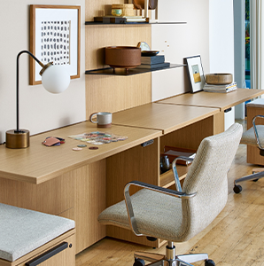 Image of a desk and chair in a private office with accessories on shelves