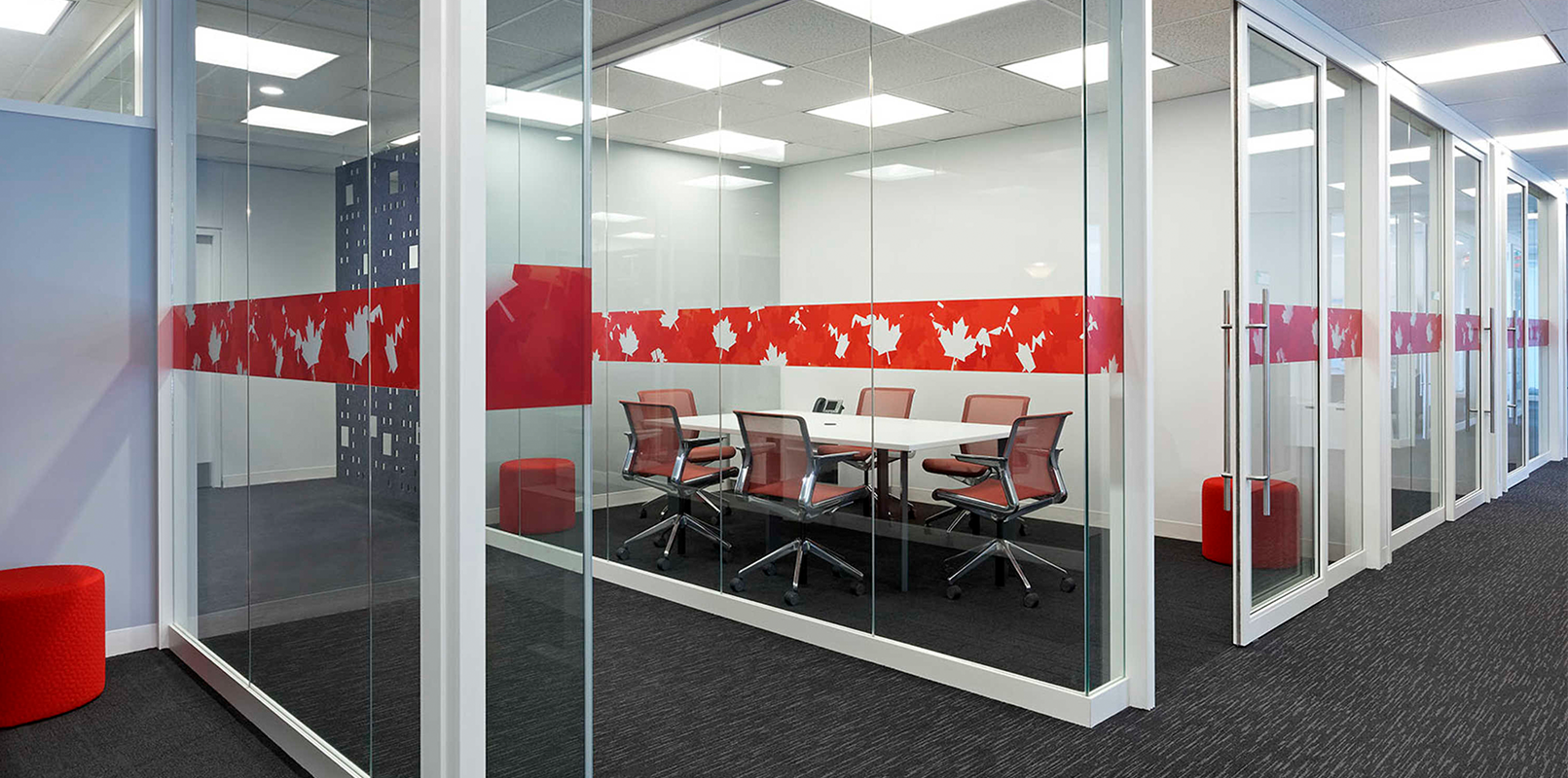 Glassed-in board room with red accents on glass