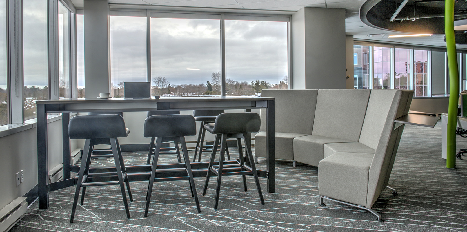 Wide view of collaboration desk and lounge sofa