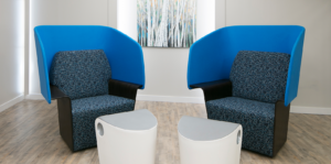 Two blue accent chairs with modern end tables